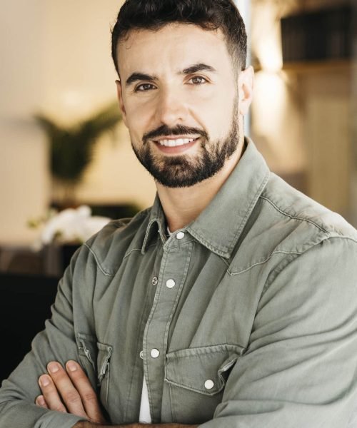 professional-man-confidently-smiling-standing-in-m-2026-03-26-10-31-53-utc.jpg